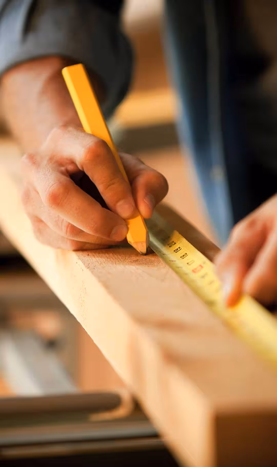 Measuring lumber with a pencil — Acumen Renovations in Kansas City